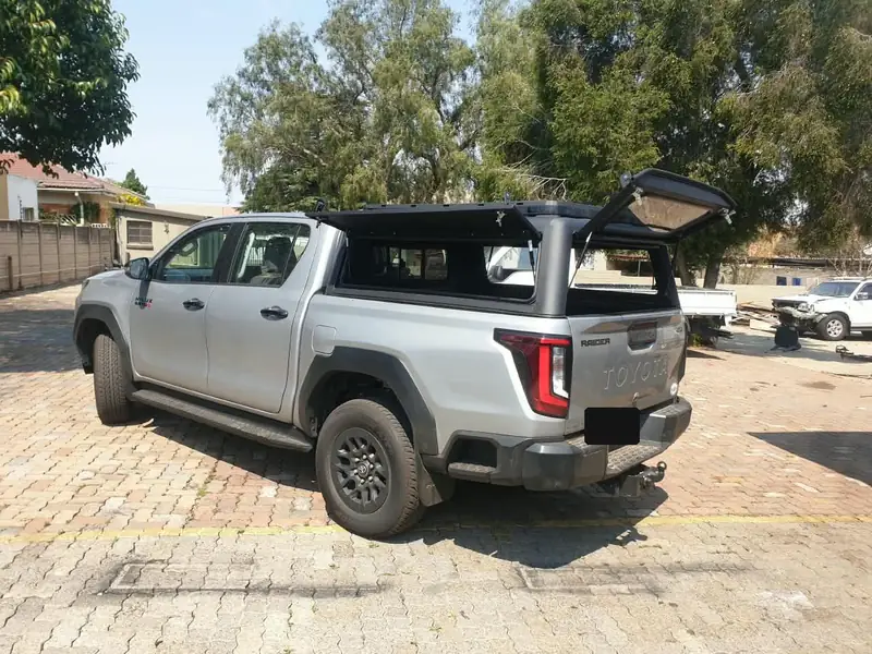 Veld Armour canopy on a Toyota Hilux with the gas-strut side door and rear door open