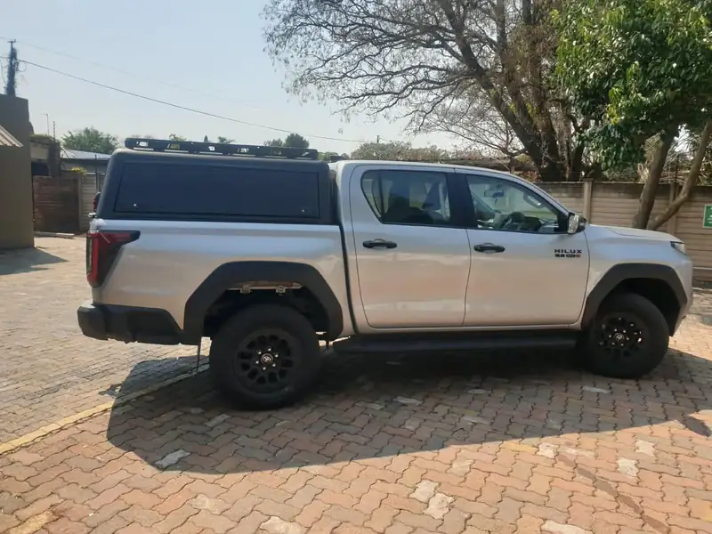 Side view of a Veld Armour canopy on a silver Toyota Hilux double cab